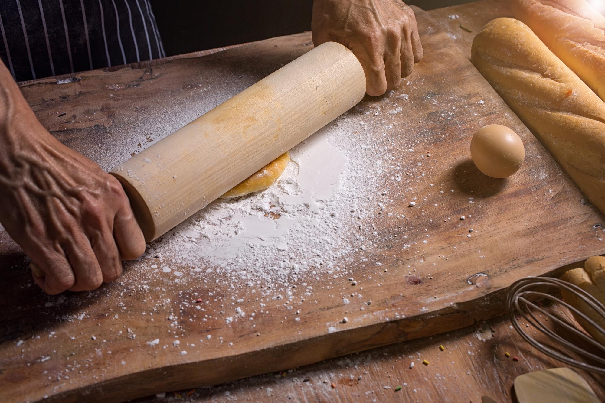 Small hands preparing dough in a bright workshop